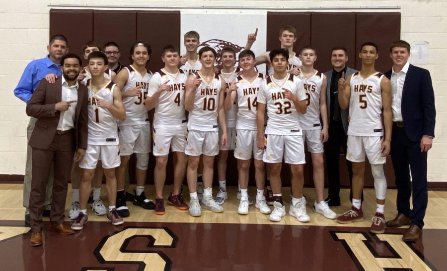 The boys basketball tea pposes for a photo after winning the game against Dodge City. This win also helped them split the WAC Title with Great Bend. 