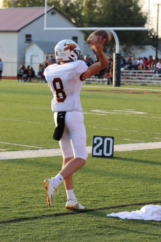 Junior Quarterback Jordan Dale warms up right before kickoff on September 11