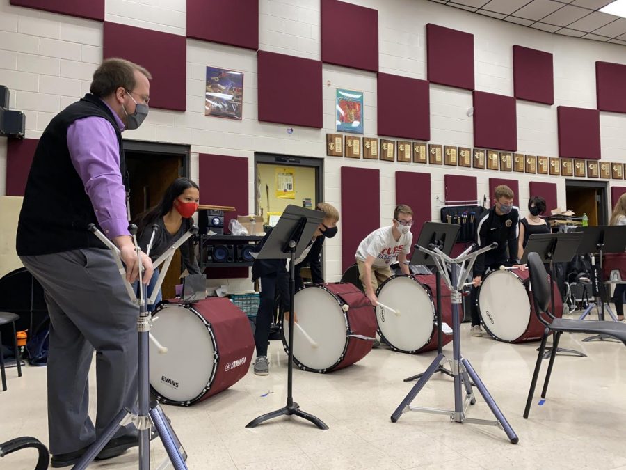 Band director Matthew Rome leads the bass drums through a difficult section in their rehearsal time during M1. Without the commitment of any marching festivals, the students will have the freedom to vary their music throughout the season.