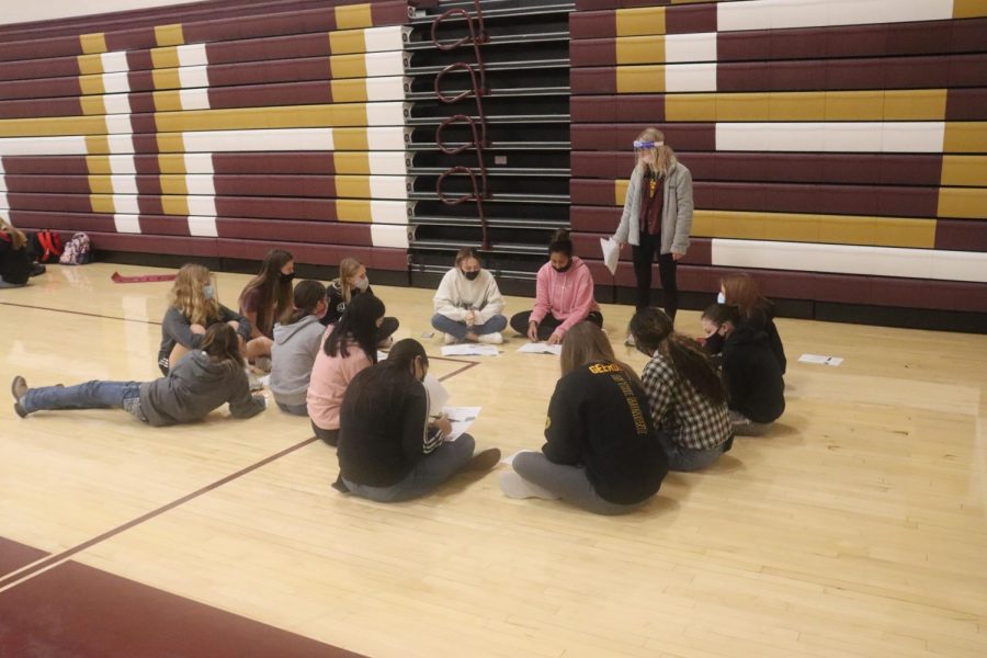 Junior Ashlynn Flax talks to her group of freshmen about why their grades and attendance rates matter during the meeting on Nov. 18. 