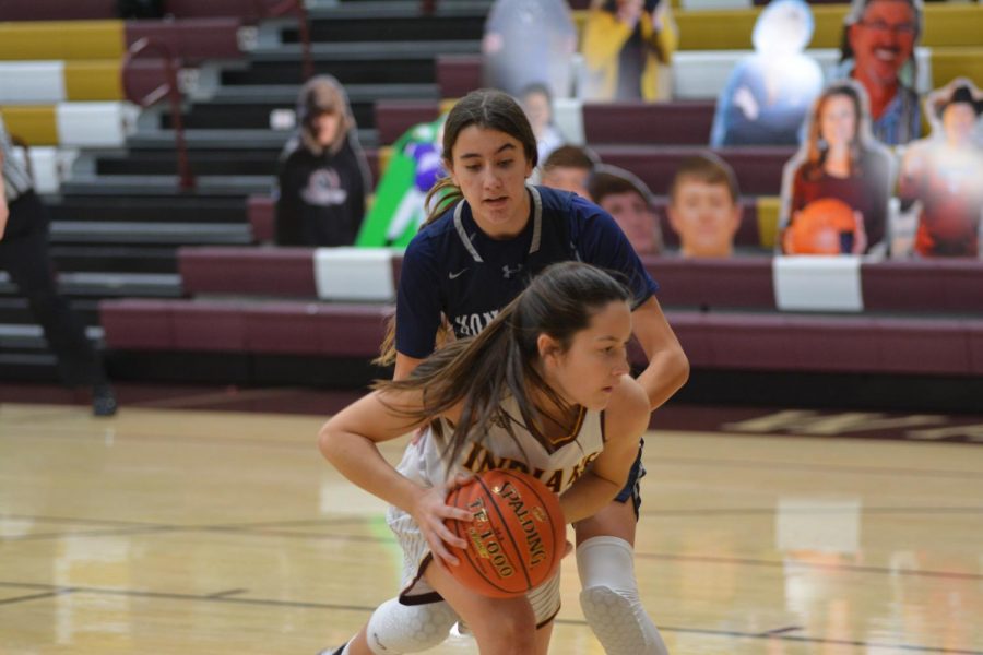 Junior Jersey Johnson shields the ball from a Thomas More Prep player during their final game of the 38th Annual Gerald Mitchell Hays City Shootout. 