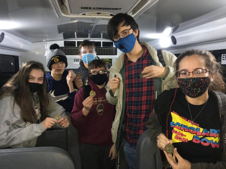 Scholars Bowl on the bus with there first place medals after the Colby meet. 