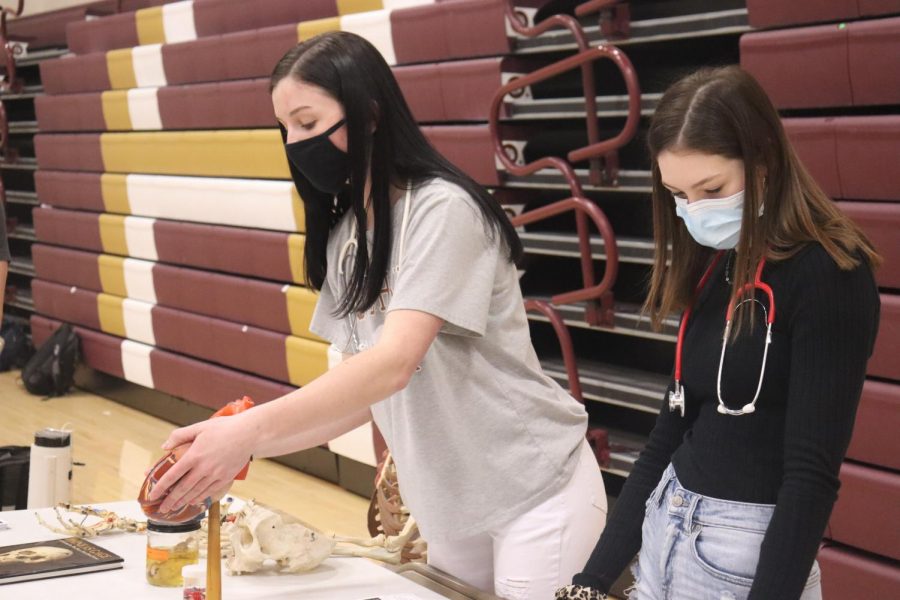 Junior McKinley Wamser (left) and senior Katie Christen (right) talk to eighth graders at the Future Medical Professionals table. Eighth graders had 45 minutes to visit each of the tables and learn about the variety of opportunities available at the high school. 