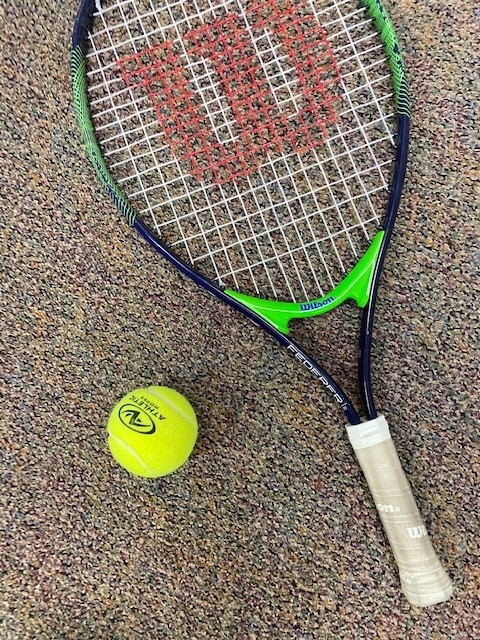 A tennis ball next tennis racket