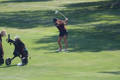 Junior Aspen Melvin hits her driver at the Hays High Invitational Tournament at Smoky Hill Country Club.