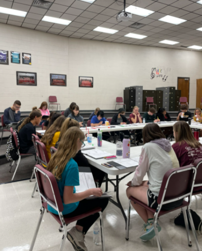 The cast of the fall musical, Urinetown, rehearses in the Hays High Choir room on Sept. 14.