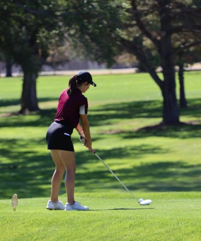 Sophomore Lily Garrison prepares to take her drive at the TMP Invitational Golf Tournament at Smoky Hill Country Club.