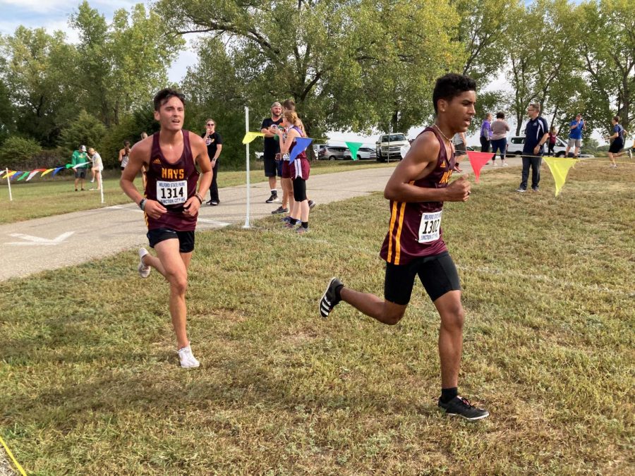 Sophomore Ty Dempsey (right) runs a few steps ahead of senior Landon Viegra.