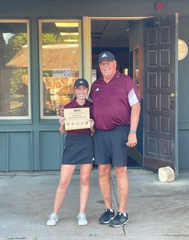 Girls golf coach Mark Watts stands with junior Katie Dinkel after being awarded WAC Player and Coach of the Year.