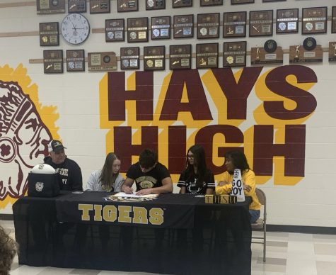 Senior Roy Moroni, along with family and friends, signs his Letter of Intent to play football for Fort Hays State University in Hays.