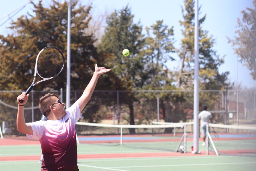 Junior Jack Scoby serves the ball while playing against Great Bend. Scoby and Sophomore Logan Schmidt finished in fourth while playing No. 2 Doubles.