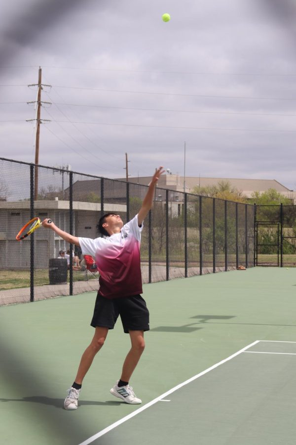 Sophomore Xavier Catura serves the ball while playing in No. 2 Singles at Fort Hays State Universitys tennis courts.