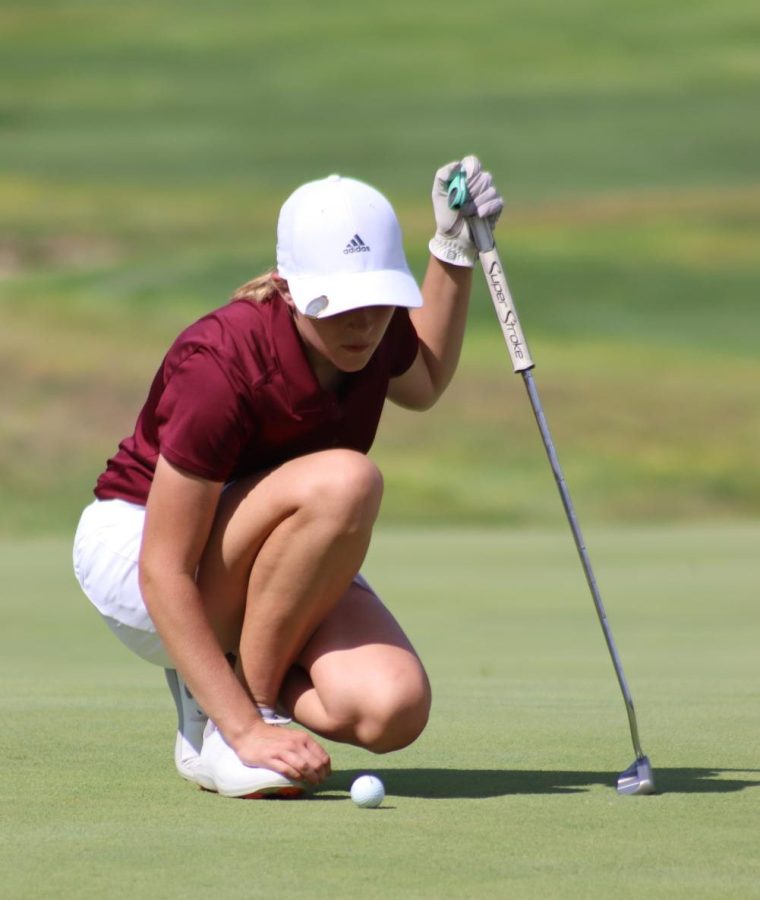 Junior Abbie Norris lines up her putt at the Smoky Hill Invitational Tournament, she shot an 81.