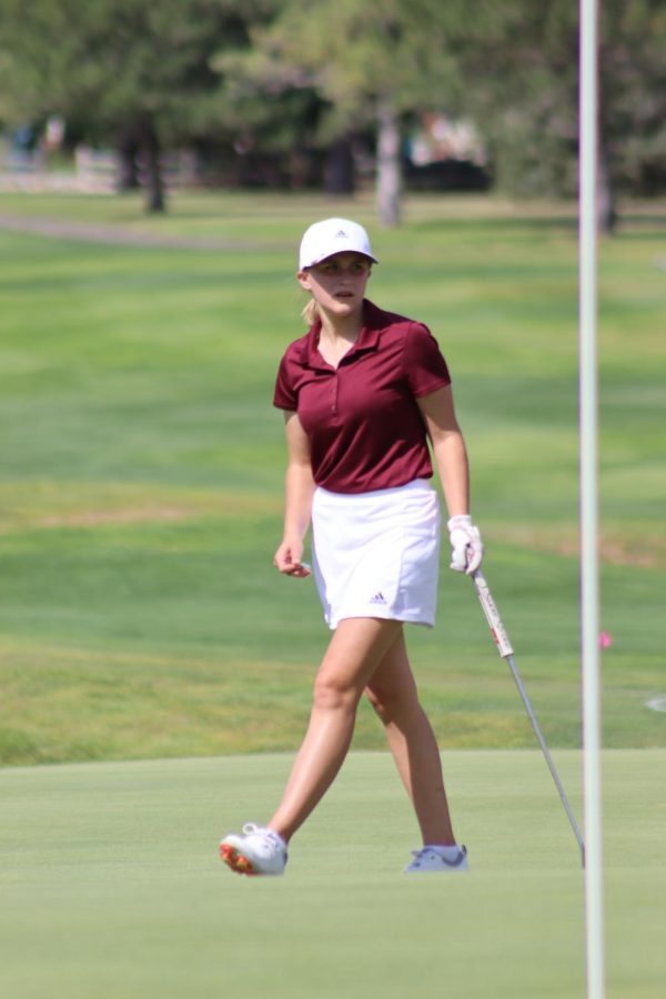 Junior Abbie Norris walks on the green during the TMP annual invitational tournament at Smoky Hill Country Club.