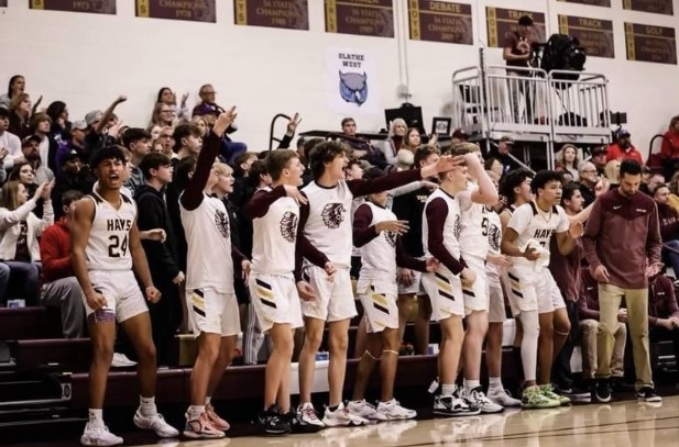 The varsity boys basketball team cheers for their teammates on Dec. 9 at Hays High School against the Junction City Blue Jays.  
