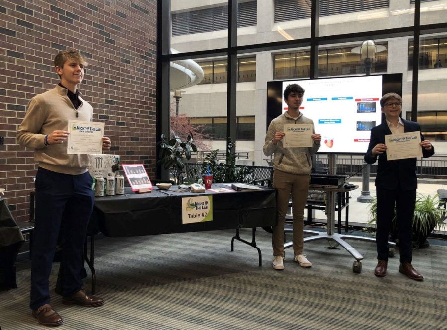Seniors Clark, Zimmerman, and Bickle pose by their first place, state winning, project based on the effects caffeine has on the body. The competition was held at the KU Medical Center in Kansas City.