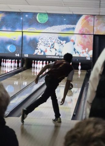 An HHS bowler watches his ball down the lane, on his second attempt at Centennial Lanes in Hays on Feb. 9.