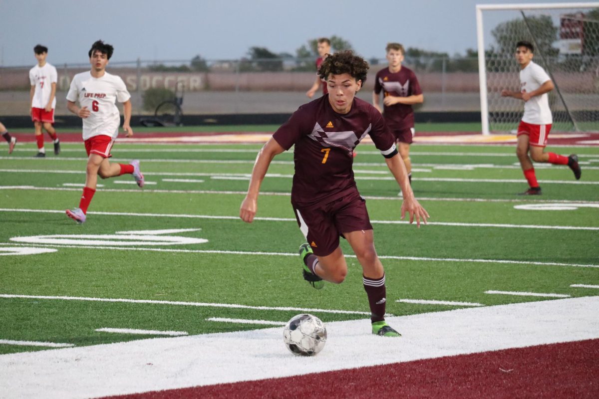 Senior Edwin Muller dribbles down the field to attack the opposing team.