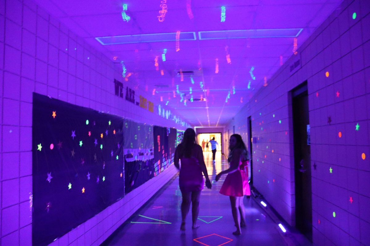 Students walk down the decorated hall to get to Gym B for the Homecoming dance. 