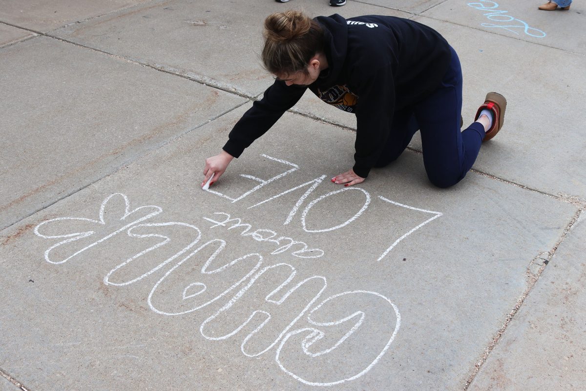 Junior Johanna Jones draws with chalk for Chalk About Love on Oct. 18. This event was organized by Jana's Campaign and the Options Student Advisory Board.