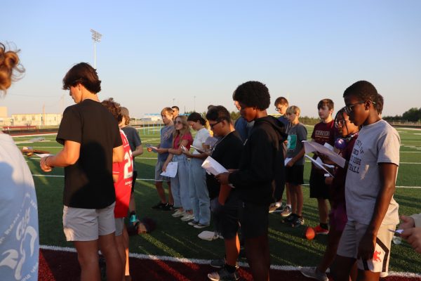 FCA members on the Football field participating in the back to school event.