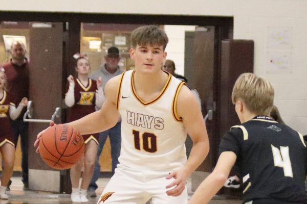 Trey Oakley brings the ball up the floor while being guarded by a Newton player.