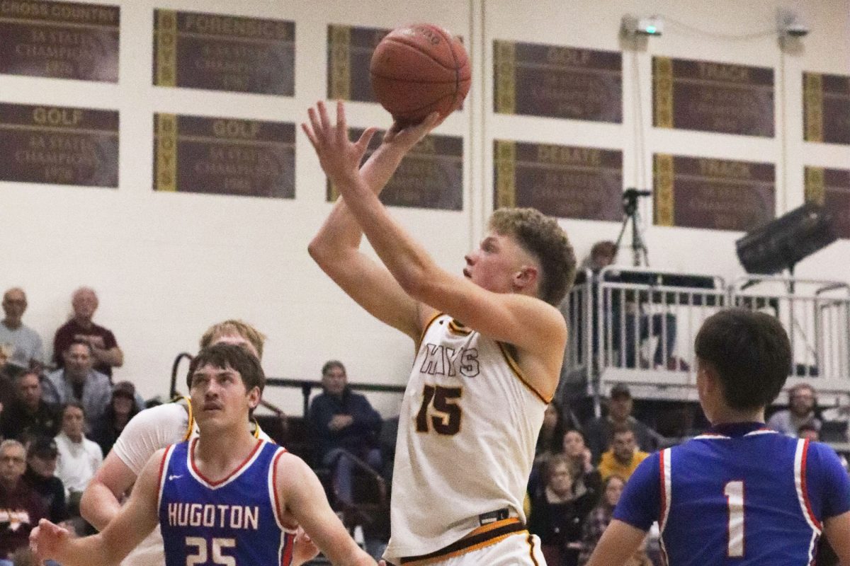 Izaac Fox attempts a shot against Hugoton in the Hays City Shootout.