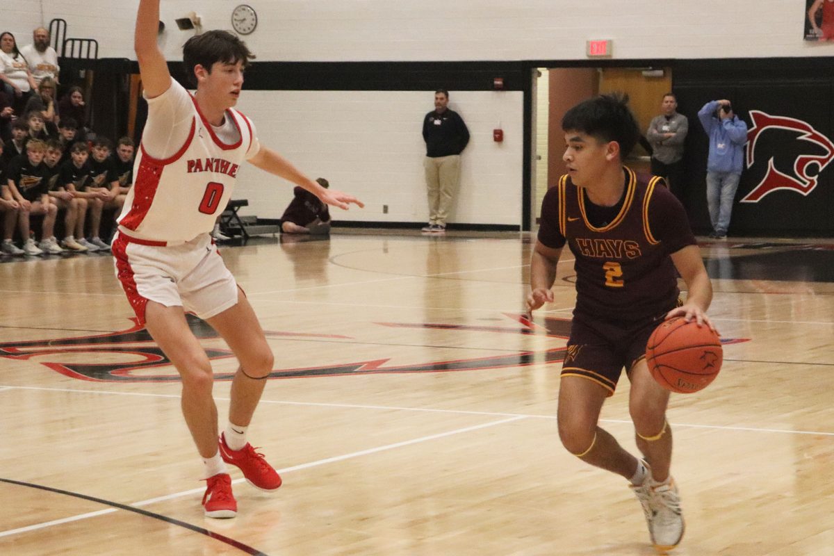 Johnny Cano tries to drive past a Panther defender in Hays High's game at Great Bend on Friday.