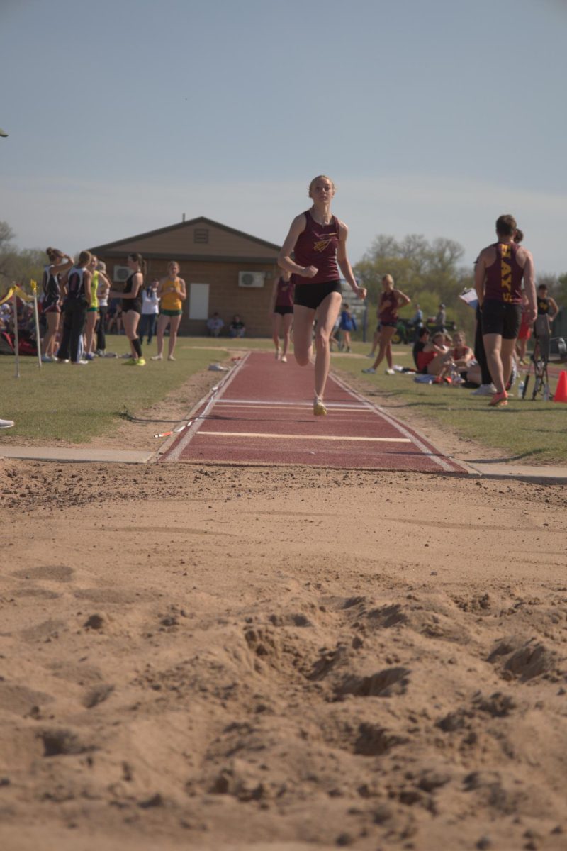 Junior Kamryn McCall prepares to jump in long jump while running down the runway at Pratt on April 11.
