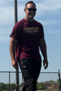 On May 13, Hays High School track head coach Kip Keeley walks around the high jump mat after watching senior Kamani Jones jump. The high jumpers were preparing for their Western Athletic Conference meet on May 15. Keeley said that this year, there has been “great improvement on the kids.” 