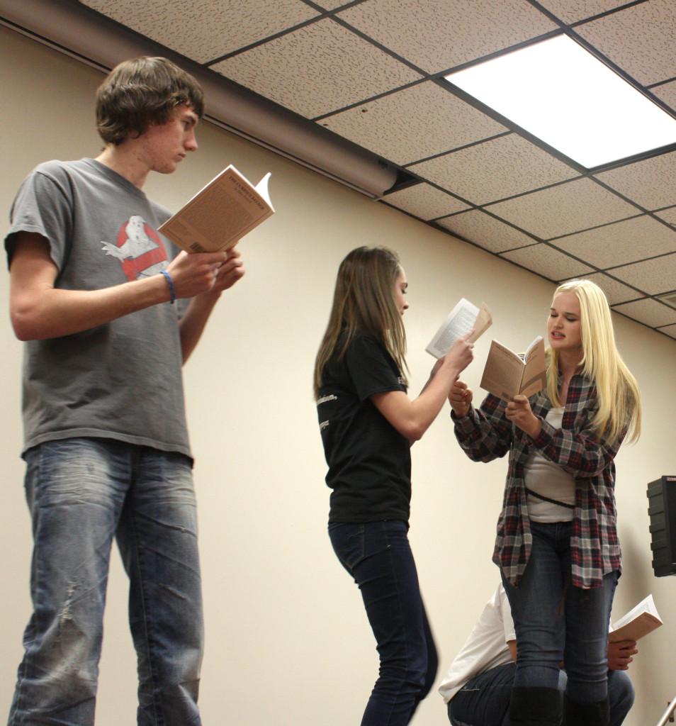 Seniors Spencer McCue and Anna Hickert with Junior Rachel Muirhead perform cold reads during auditions.