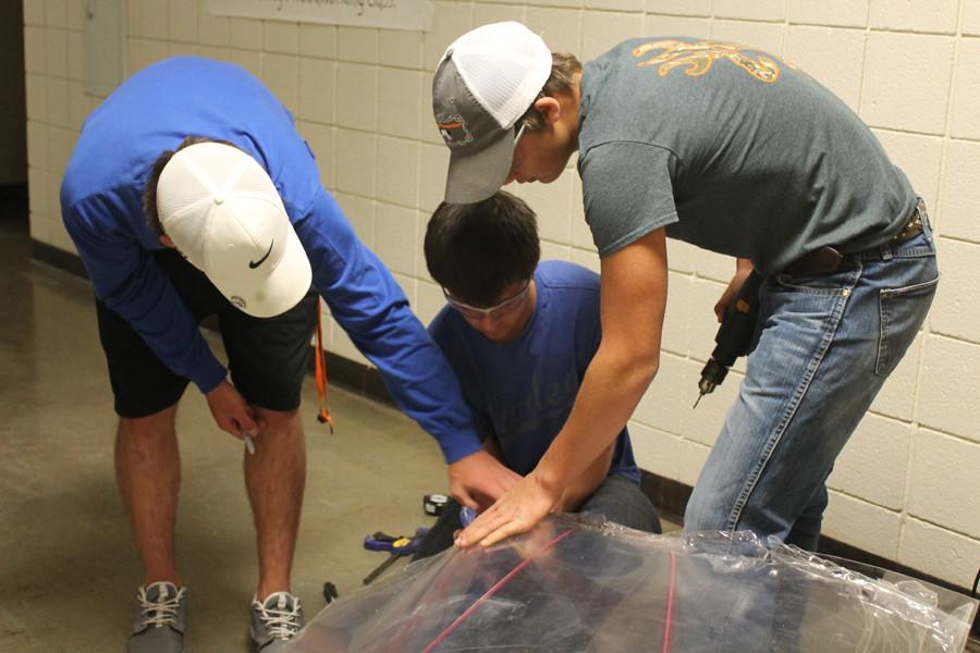 Students work on their electric car the day before a race.
