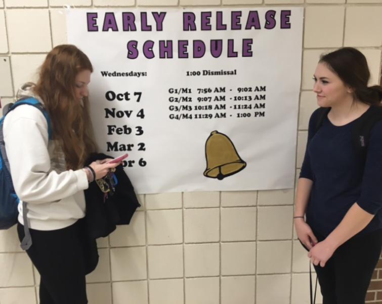 Seniors+Courtney+Ellis+and+Bethany+Kuhn+stand+in+front+of+the+early+release+poster.