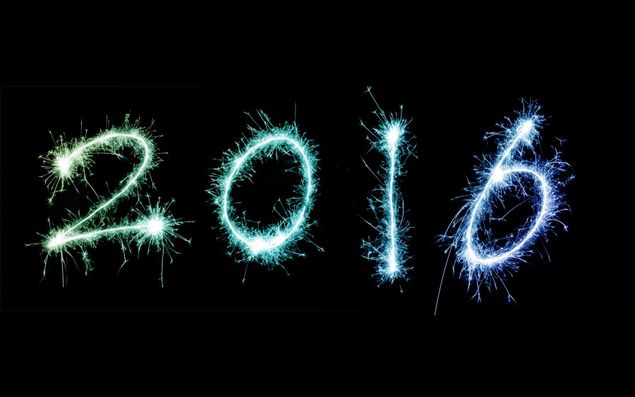 2016 New Year celebration display with the date outlined with fiery sparklers in green and blue on a black background