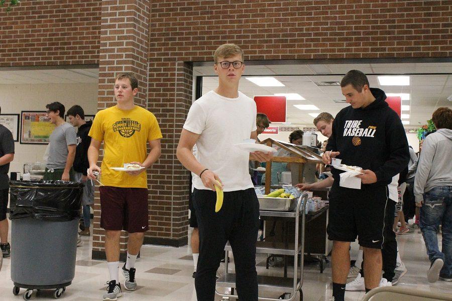 Senior Ryan Fort carries his breakfast to a table during the Breakfast of Champions.