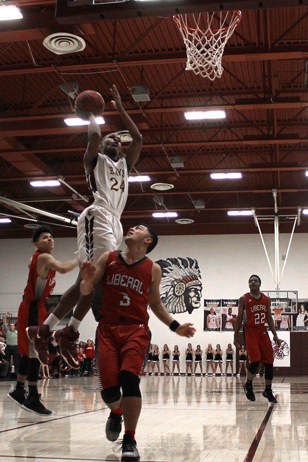Senior Claiborne Kyles pulls up for floater  against Liberal player during game on Feb. 10.