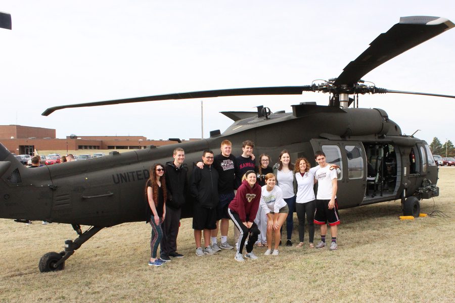 Instructor Abby Maska stands in front of one of the helicopters with her senior AP government class. 