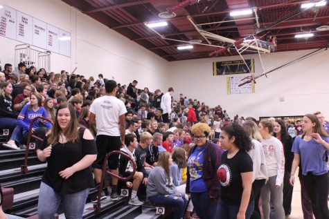 Kelly Barnes speaks with students during assembly