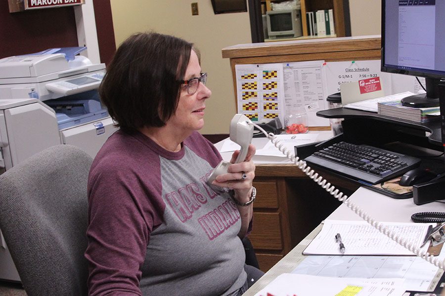 Sue Rouse works in the office as a receptionist, answering calls, making announcements and checking in visitors.