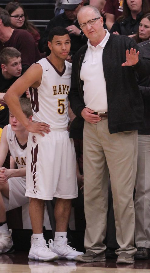 Head coach Rick Keltner instructs senior point guard Ethan Nunnery after coming out of the game.