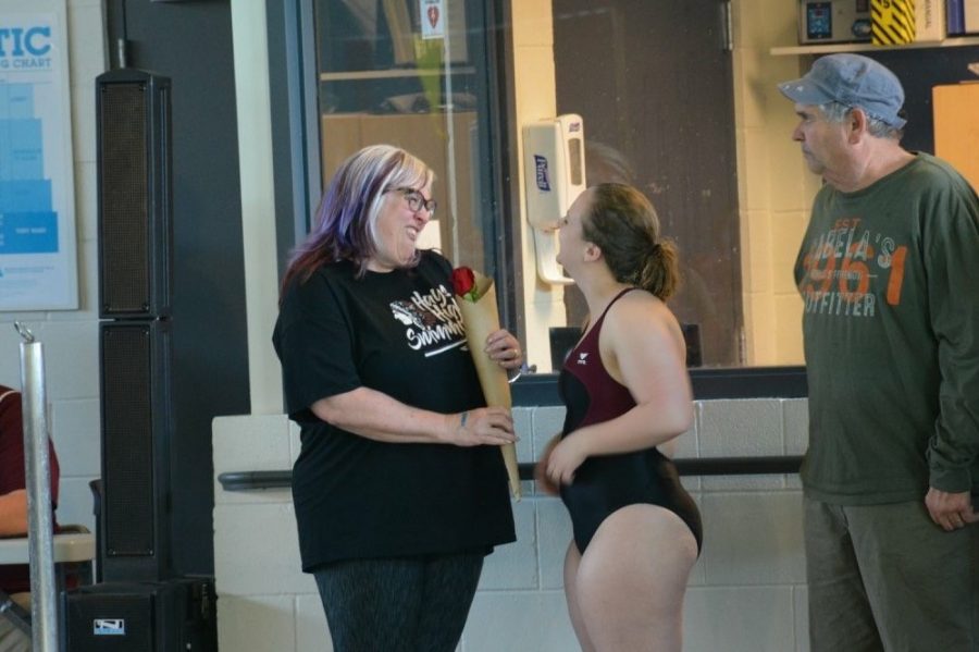 Senior Kyra Polifka-Wilhelm and her mother share a moment together at the meet.