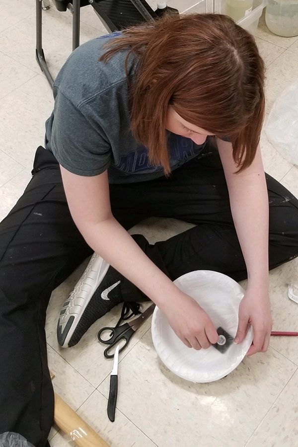 Freshman Callie Raacke works on a version of her hovercraft she has built for state competition. This specific version will not be competing but it was one of the models being tested. Raacke placed second at regional competition in this event.