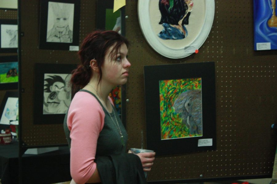 Junior Katie Vaughn looks at the art exhibits at the FHSU art walk. 