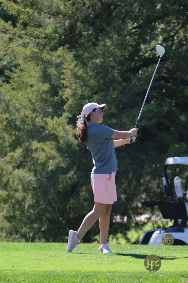 Sophomore+Sophia+Garrison+watches+her+tee+shot+at+the+home+tournament.