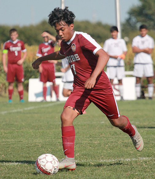 Sophomore Brian Cisneros opens up to pass the ball up the field in action against Great Bend, which resulted in a 3-0 loss.