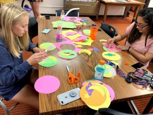 Students Claire Shippy and Cristina Leos work on Homecoming decorations.
