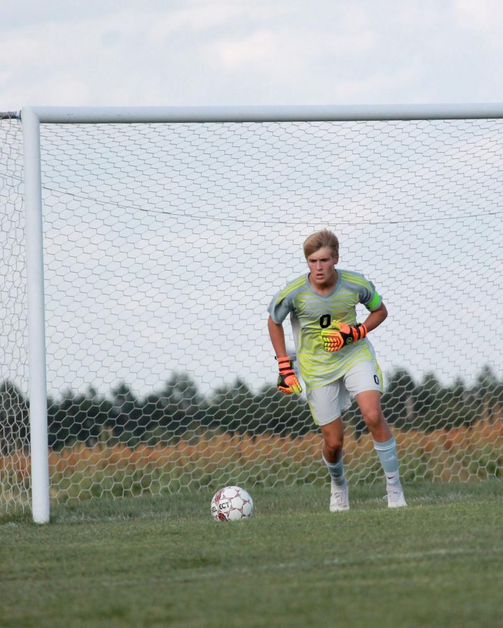 Senior Connor Teget runs up for a goal kick in in the minutes leading up to a lightning delay. The game resulted in a 2-1 loss for the Indians .