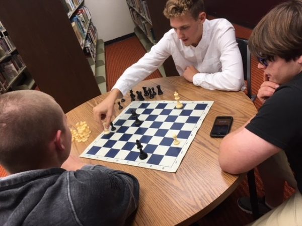 Seniors Cade Swayne and Spencer Wittkorn play a game of chess during a Chess Club meeting. 