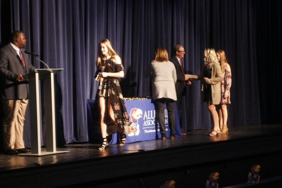 Senior Alyssa Underwood shakes University of Kansas Chancellor Douglas Girod as she receives her medallion. 