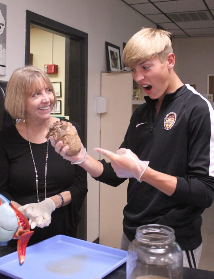 Senior Connor Teget holds the heart in his M4 Human Biology class.